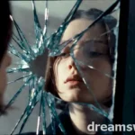 A shattered mirror reflecting a fragmented face, symbolizing broken self-image and subconscious fear in a dream